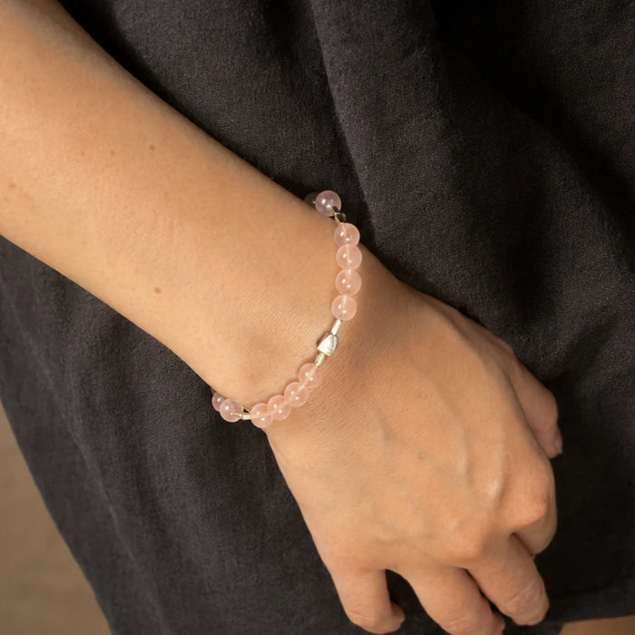 First Blush Poise Bracelet worn on the wrist, showing its soft pink rose quartz and delicate silver details