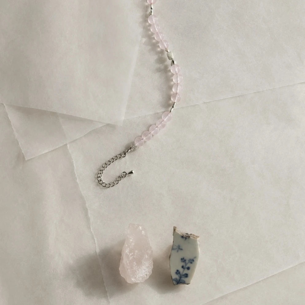 Detail of the First Blush Poise Bracelet showing the lobster clasp, extender chain, and rose quartz beadwork