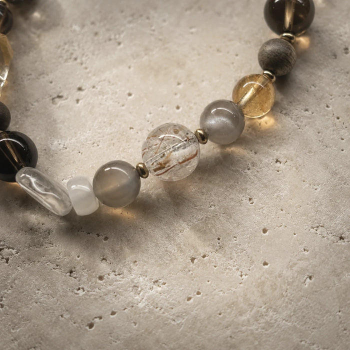 Close-up of the Strata Afterglow Bracelet showing citrine, white moonstone, smoky quartz, wood, and brass details