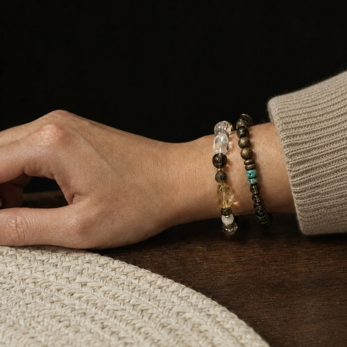 Strata Dusk Passage Bracelet worn on the wrist, showing its smoky quartz, sandalwood, and turquoise composition