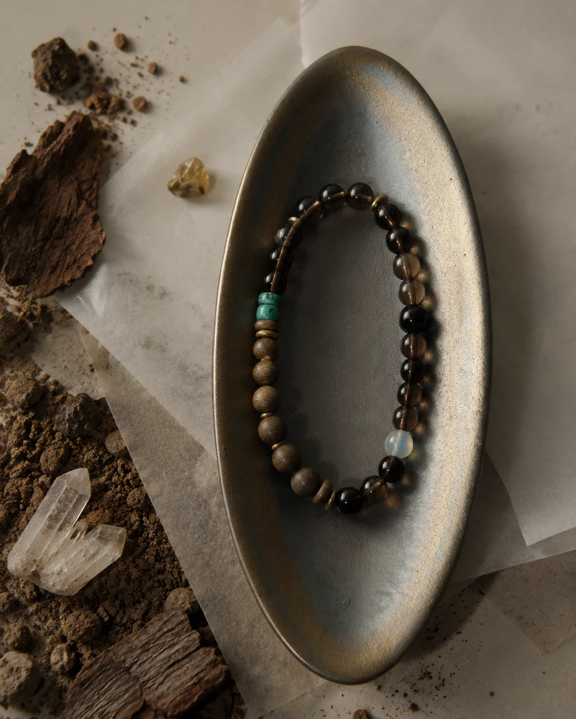 Strata Dusk Passage Bracelet styled with warm brown stones, sandalwood, turquoise, and brass accents