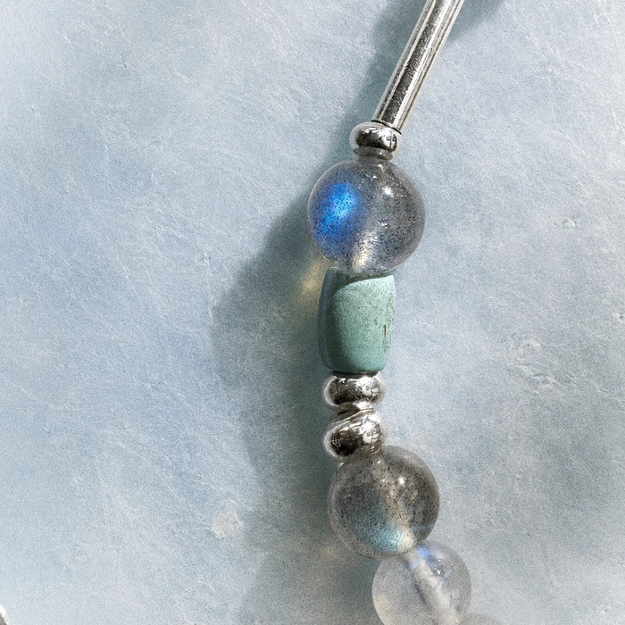 Close-up of the Veiled Light Blue Hour Bracelet with moonstone, turquoise, obsidian, sandalwood, and 925 sterling silver details