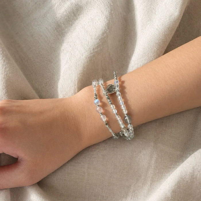 Veiled Light Echo Bracelet worn on the wrist, showing its double-wrap moonstone and sterling silver composition
