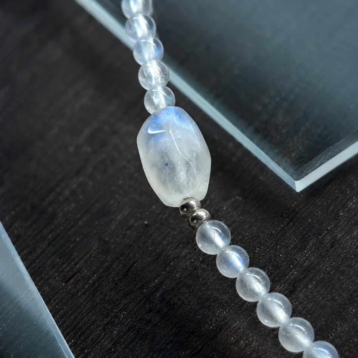Close-up of the Veiled Light Echo Bracelet with blue moonstone, grey moonstone, obsidian, and sterling silver accents