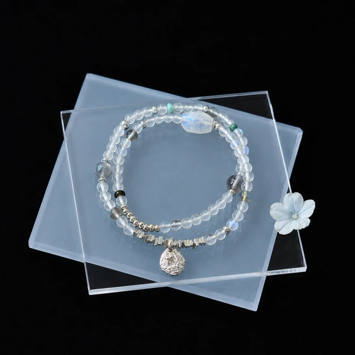 Veiled Light Echo Bracelet styled on a dark display with moonstone, turquoise, obsidian, and silver details