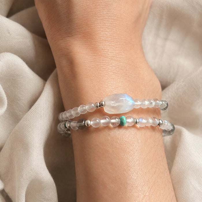 Close-up wrist view of the Veiled Light Echo Bracelet showing its layered double-wrap structure