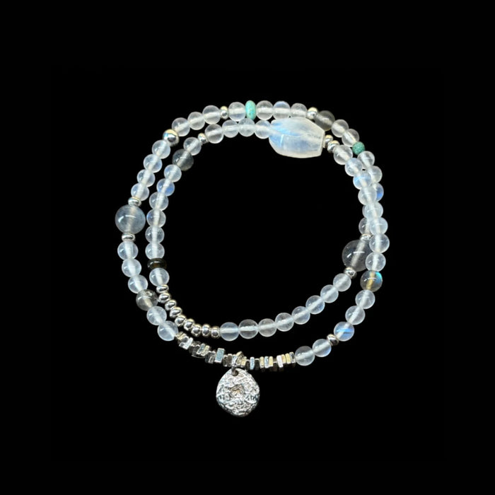 Veiled Light Echo Bracelet on a black background with blue and grey moonstone, obsidian, turquoise, and sterling silver