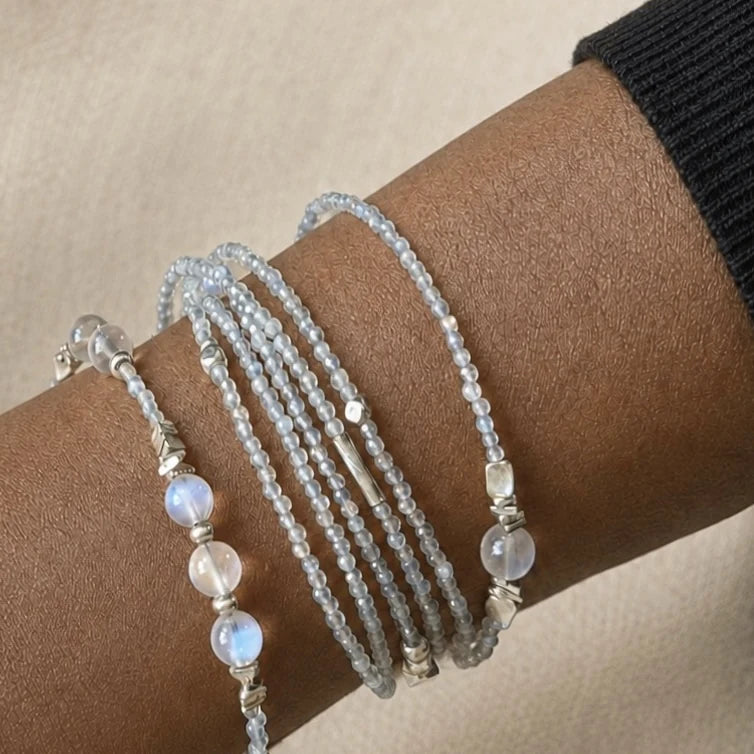 Veiled Light Moon Dust Bracelet wrapped around the wrist, showing fine grey moonstone strands and larger moonstone accents