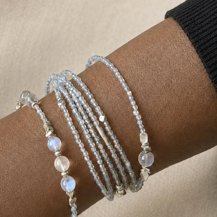 Veiled Light Moon Dust Bracelet wrapped around the wrist, showing fine grey moonstone strands and larger moonstone accents