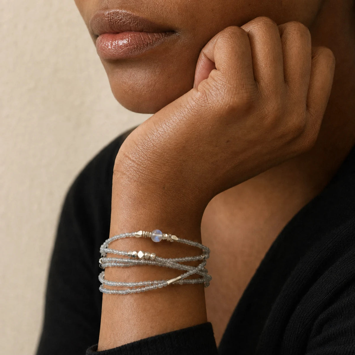 Veiled Light Moon Dust Bracelet worn in multiple wraps, showing its delicate grey moonstone texture on the wrist
