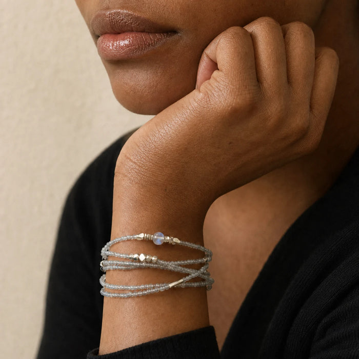 Veiled Light Moon Dust Bracelet worn in multiple wraps, showing its delicate grey moonstone texture on the wrist