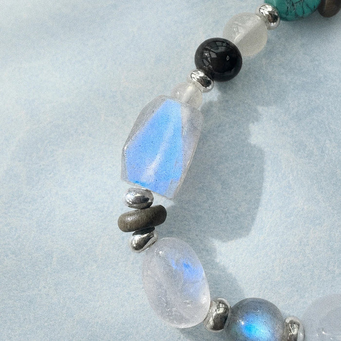 Close-up of faceted blue moonstone, grey moonstone, obsidian, and 925 sterling silver on the Prism Bracelet