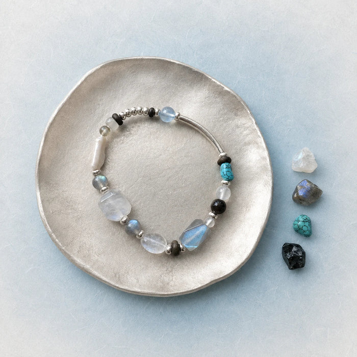 Veiled Light Prism Bracelet styled on a silver dish with moonstone, labradorite, aquamarine, and turquoise accents