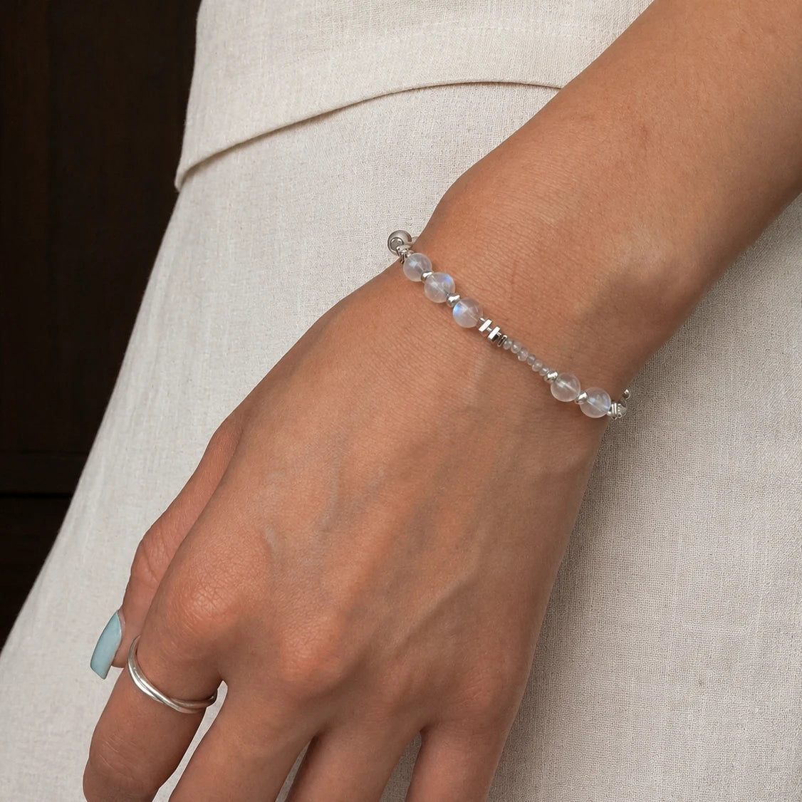 Veiled Light Trace Bracelet worn alone on the wrist, showing its delicate moonstone proportions